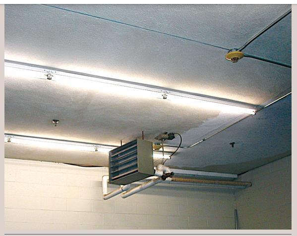 The picture shows two sprinklers installed in the vicinity of a unit heater.