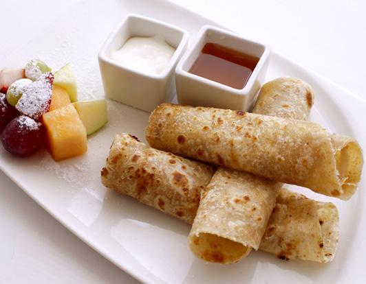 BREAKFAST الألفطار المميز Chapatti and karak, chapatti bread, cream cheese and honey, served